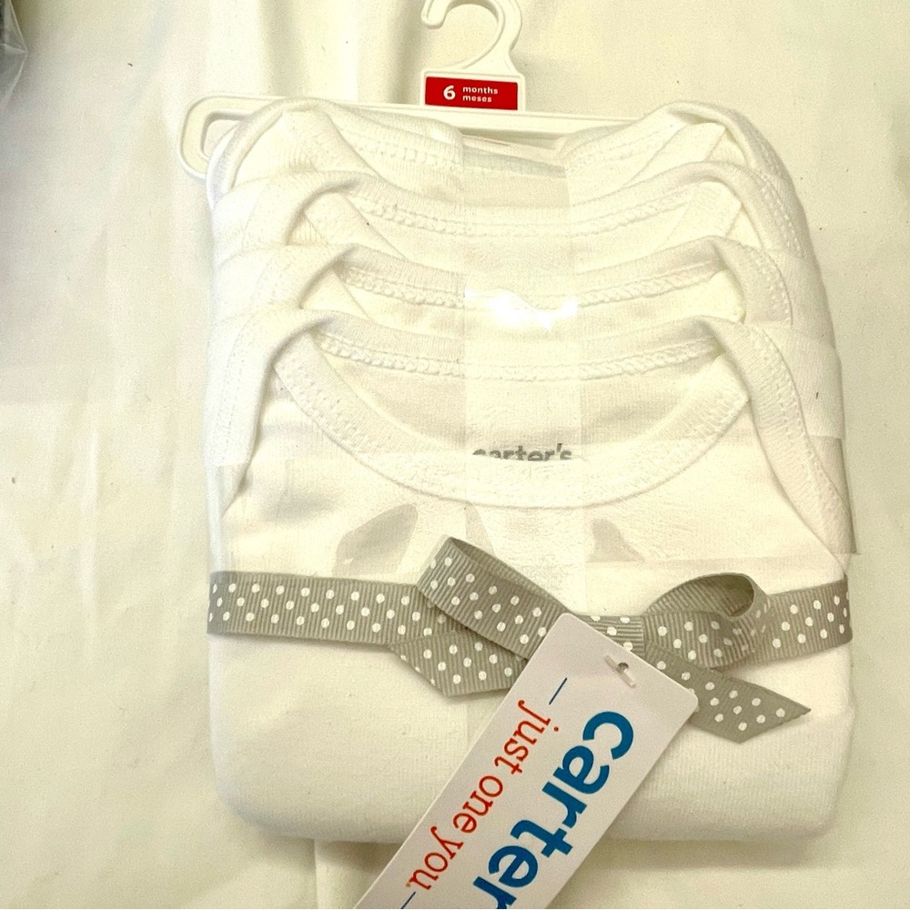 4 pack short sleeve onesie in white by Carters.
